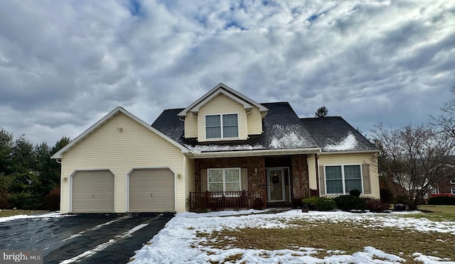 view of front of home with covered porch and a garage