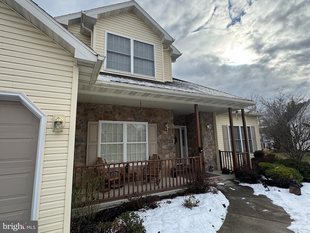 view of front of property featuring covered porch and a garage