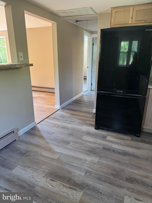 145 Press Ave, Browns Mills, NJ 08015 - kitchen with freestanding refrigerator, a baseboard heating unit, light wood-type flooring, light brown cabinetry, and baseboards