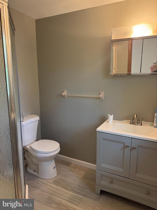 145 Press Ave, Browns Mills, NJ 08015 - bathroom featuring toilet, vanity, baseboards, and wood finished floors
