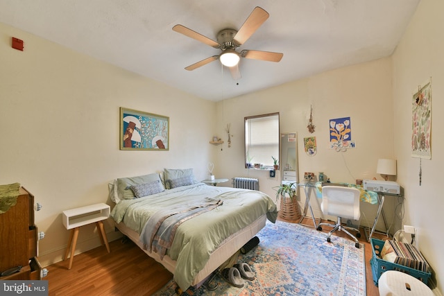 bedroom featuring radiator, ceiling fan, and wood-type flooring