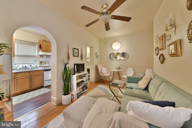 living room featuring ceiling fan and light wood-type flooring