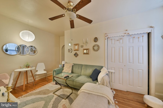 living room featuring ceiling fan and hardwood / wood-style floors