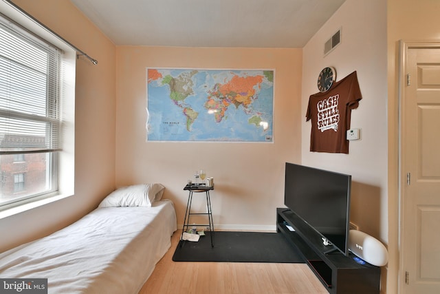 bedroom with hardwood / wood-style floors