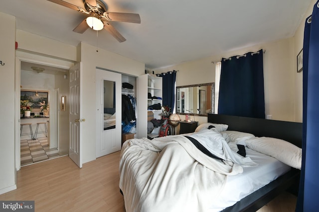 bedroom featuring light wood-type flooring, ceiling fan, and a closet