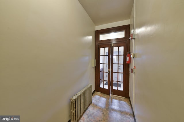 doorway to outside featuring radiator heating unit and french doors