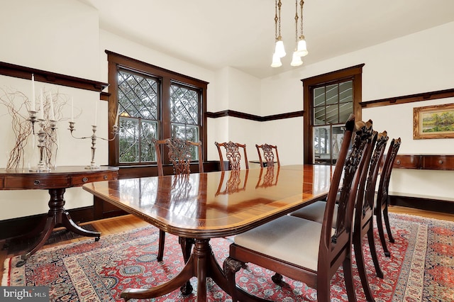 dining area featuring a notable chandelier and wood finished floors