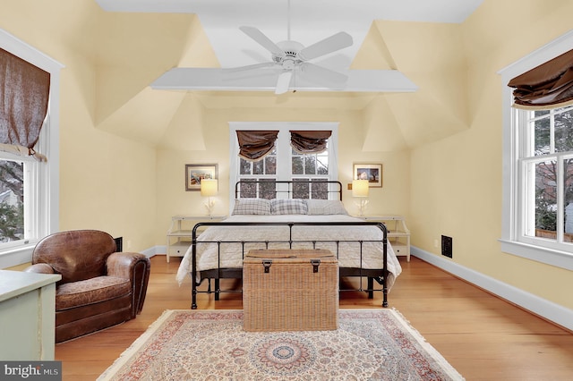 bedroom featuring a ceiling fan, light wood-type flooring, and baseboards