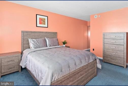 bedroom featuring dark colored carpet