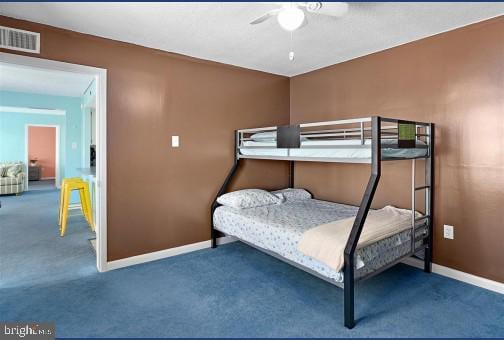 bedroom featuring ceiling fan and dark colored carpet