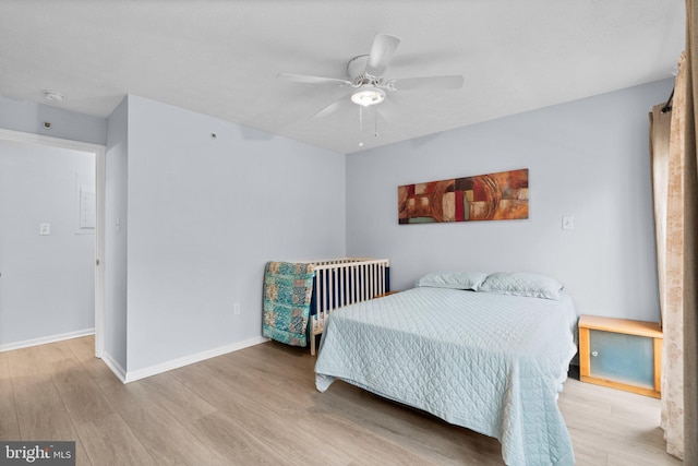 bedroom with light hardwood / wood-style floors and ceiling fan