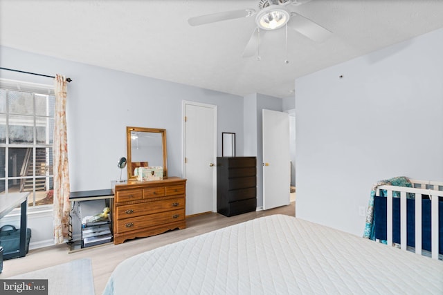 bedroom with ceiling fan and light hardwood / wood-style flooring