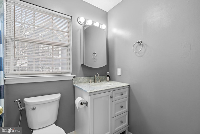 bathroom featuring vanity and toilet