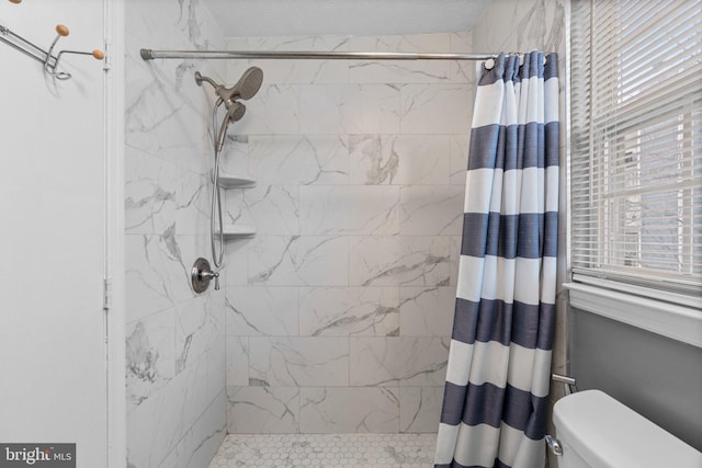 bathroom with toilet, a wealth of natural light, and a shower with shower curtain