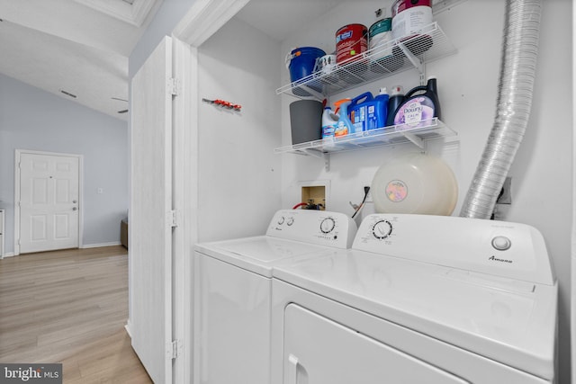 washroom featuring washing machine and dryer and light wood-type flooring