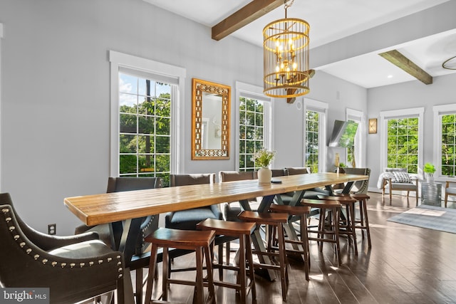 dining room with dark wood-type flooring, beam ceiling, and an inviting chandelier