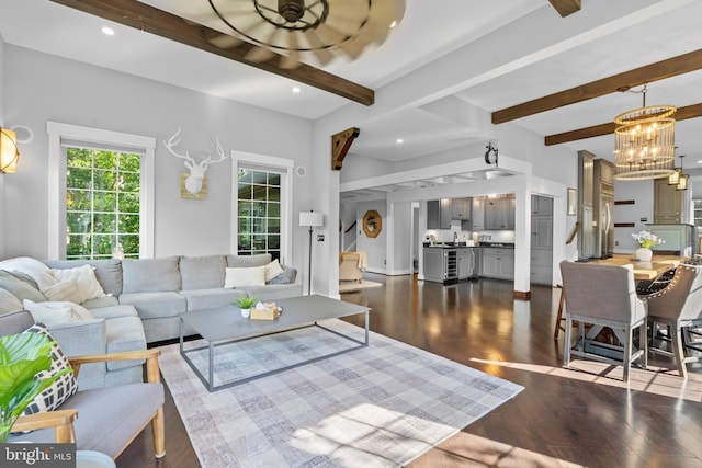 living room with dark hardwood / wood-style flooring, beam ceiling, and a notable chandelier