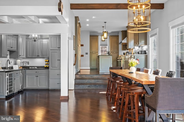 kitchen featuring decorative light fixtures, a notable chandelier, beamed ceiling, and gray cabinetry