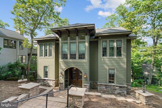 back of property with french doors and a patio