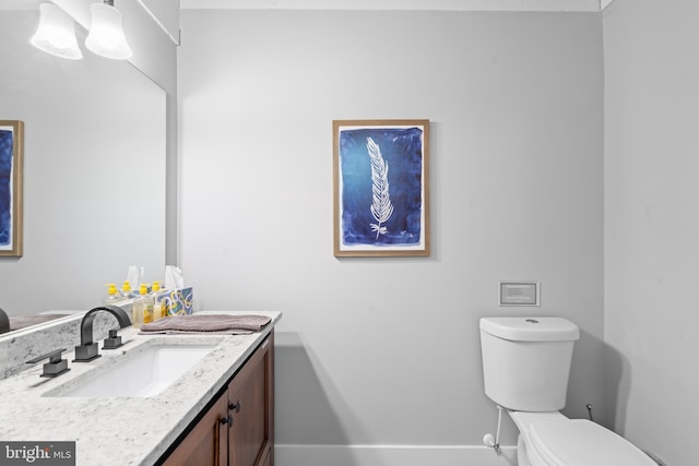 bathroom featuring toilet and vanity