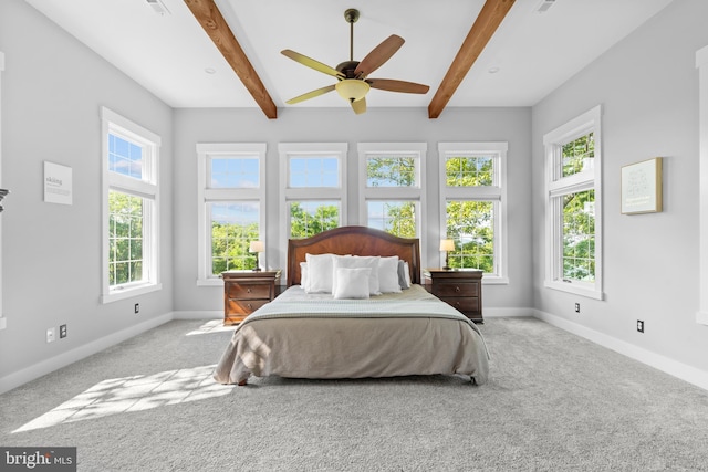 bedroom featuring beam ceiling, light colored carpet, and ceiling fan