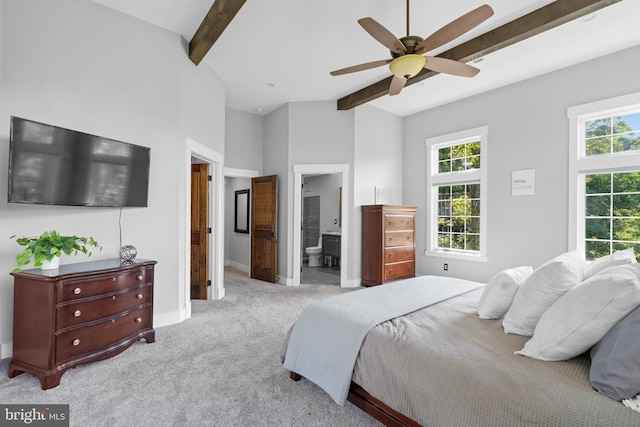 carpeted bedroom featuring ceiling fan, connected bathroom, high vaulted ceiling, and beam ceiling