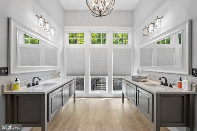 bathroom with vanity, plenty of natural light, and a chandelier