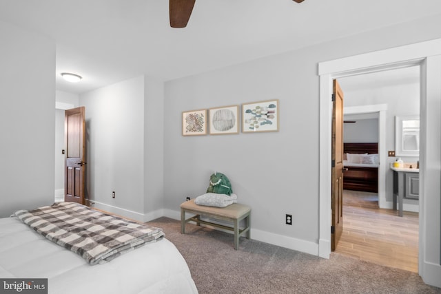 carpeted bedroom featuring ceiling fan and ensuite bath