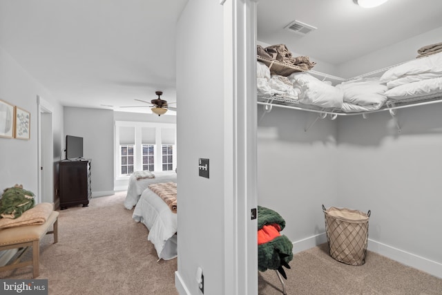 bedroom featuring light carpet and ceiling fan