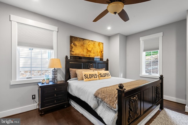 bedroom with ceiling fan and dark hardwood / wood-style flooring