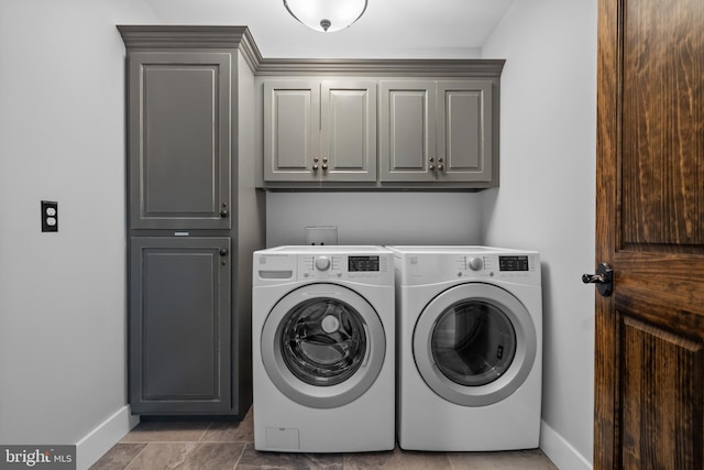 washroom with washer and clothes dryer and cabinets