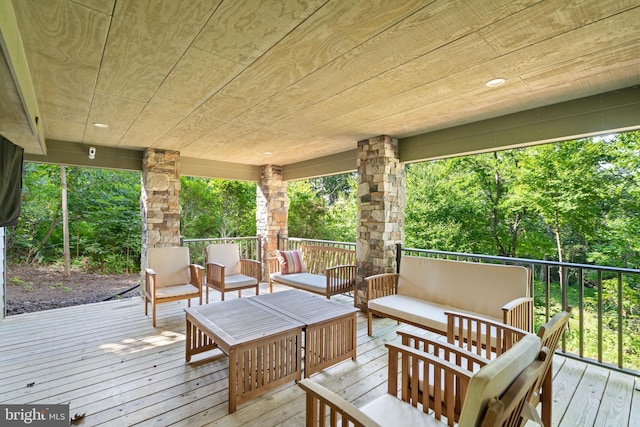 wooden deck with an outdoor living space