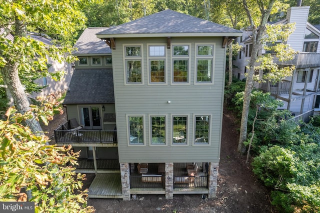 back of property featuring a wooden deck