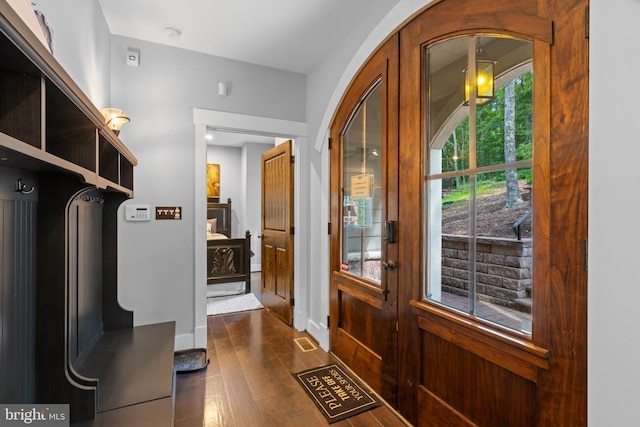 doorway with dark wood-type flooring