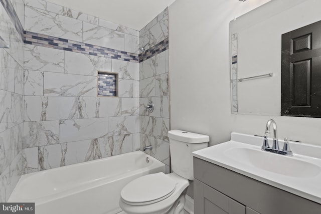 full bathroom featuring toilet, tiled shower / bath combo, and vanity