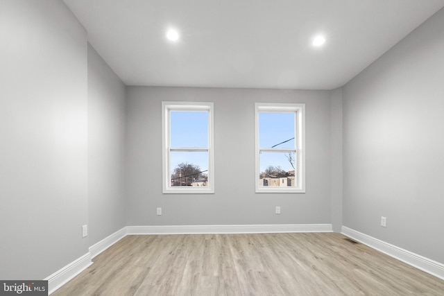 spare room with light hardwood / wood-style floors