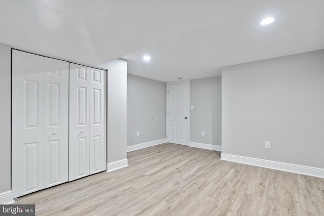 unfurnished bedroom featuring light wood-type flooring and a closet