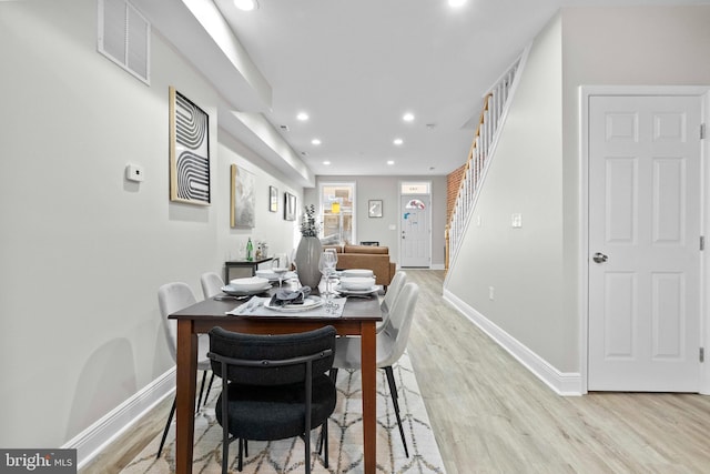 dining space with light hardwood / wood-style flooring