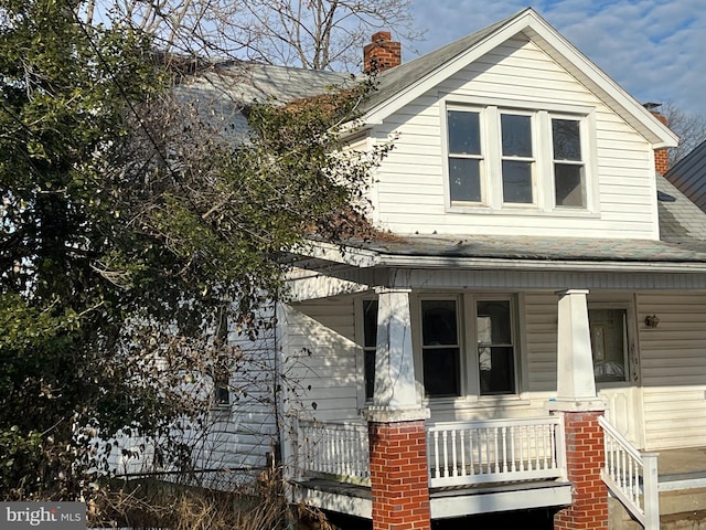 view of side of property with a porch