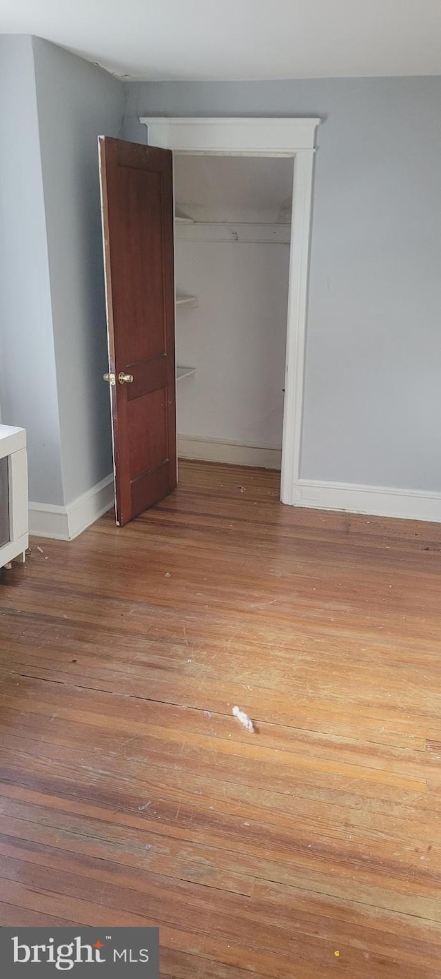 unfurnished bedroom featuring light hardwood / wood-style floors and a closet