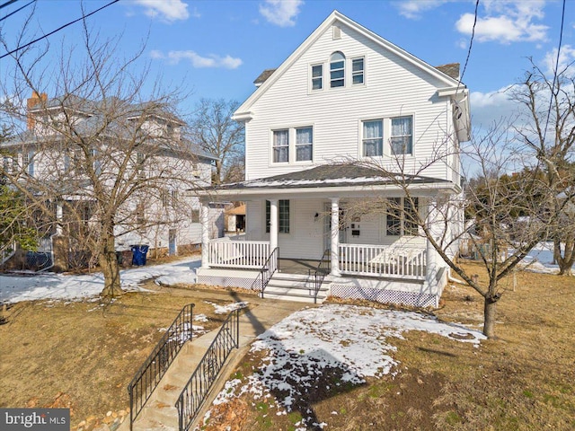 view of front of house featuring a yard and covered porch