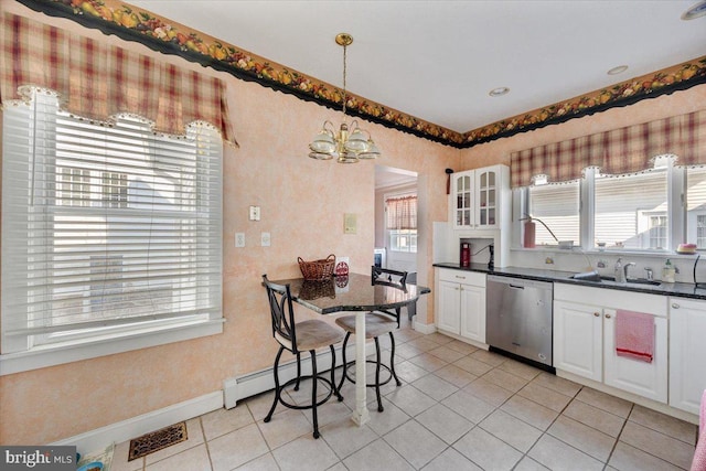 kitchen featuring pendant lighting, light tile patterned floors, white cabinetry, and dishwasher