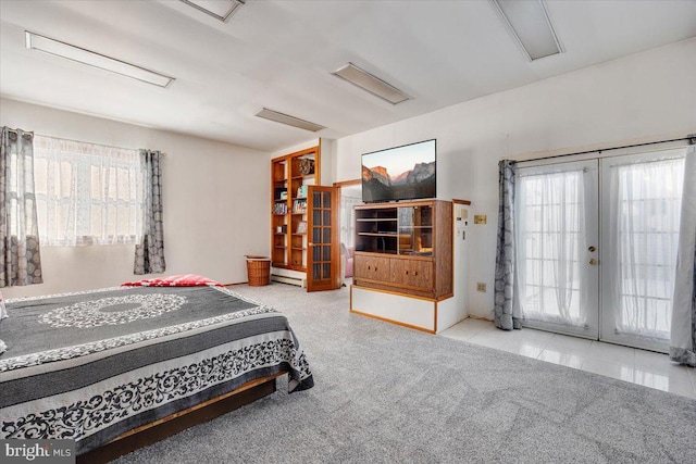 bedroom featuring french doors, access to exterior, baseboard heating, and light tile patterned floors