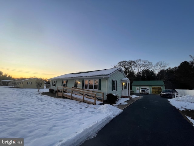 view of front of property with a garage and an outdoor structure