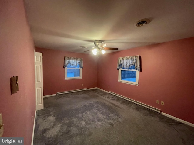 unfurnished room with a baseboard heating unit, ceiling fan, and dark carpet