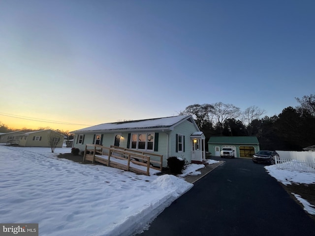 view of front of property with a garage and an outdoor structure