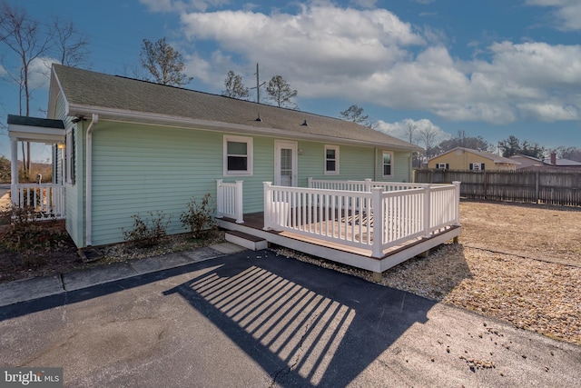 rear view of house with a wooden deck