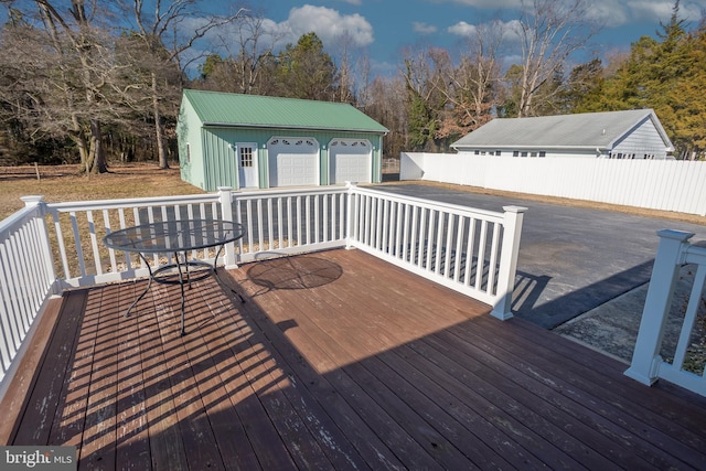 deck featuring an outbuilding and a garage