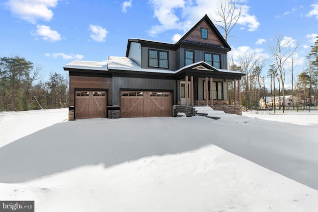 view of front of house with covered porch and a garage