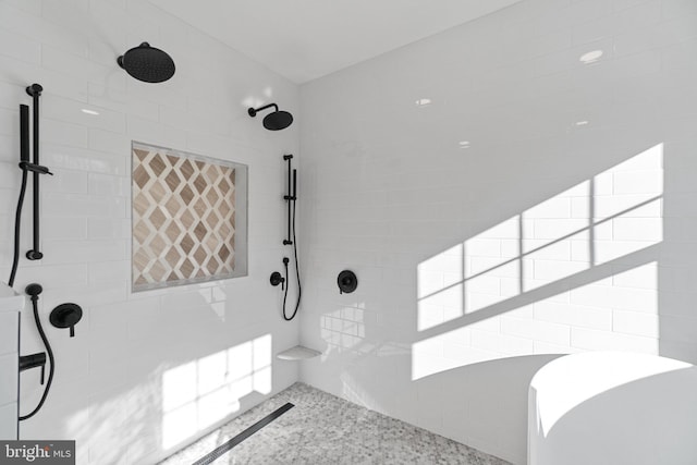 bathroom featuring a tile shower and speckled floor